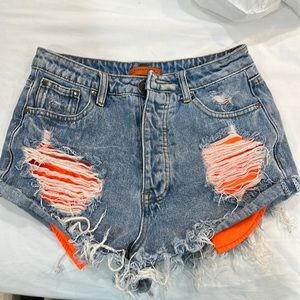 Denim shorts with orange pockets